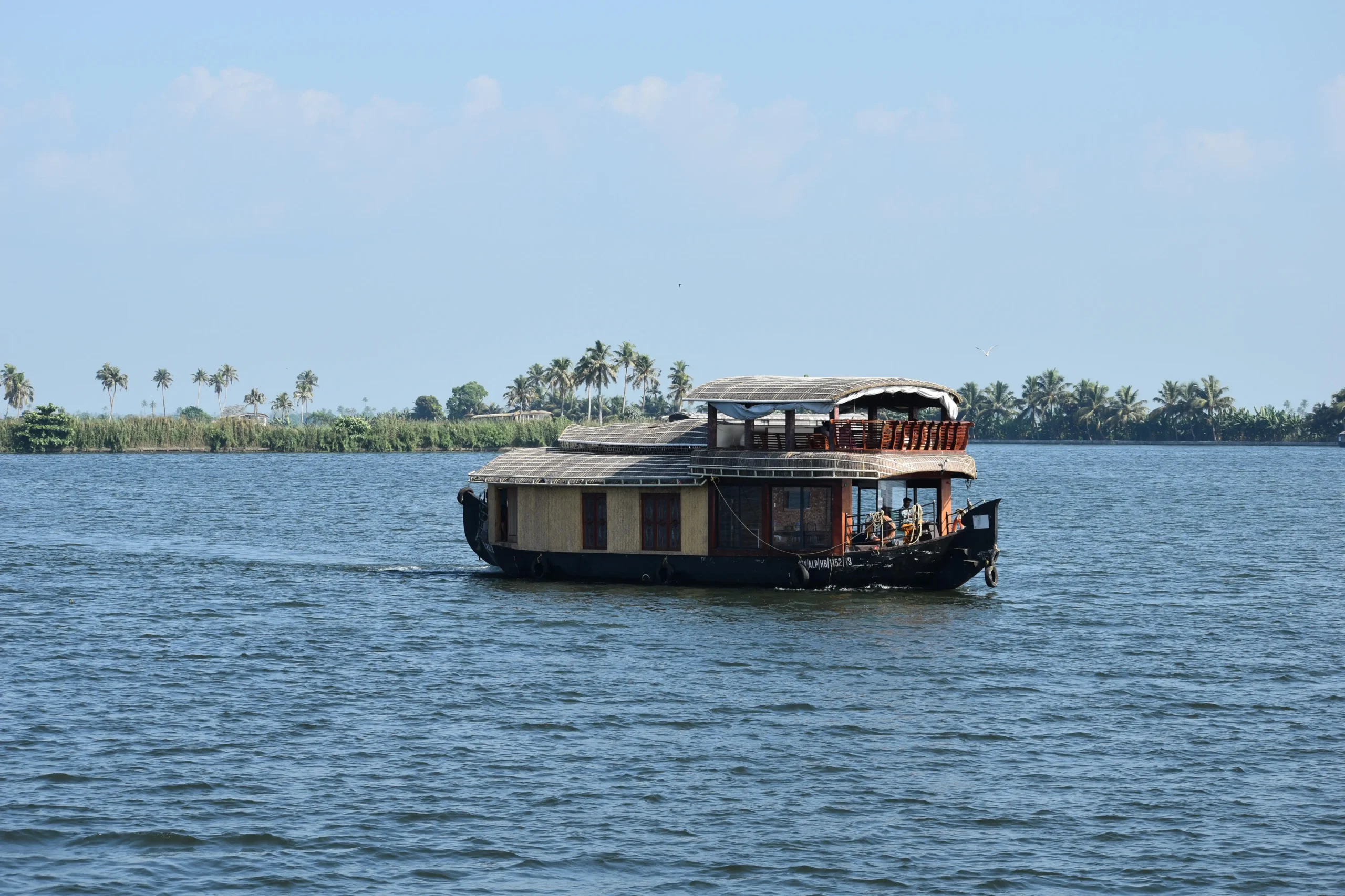 Luxury houseboat gliding across Alleppey backwaters